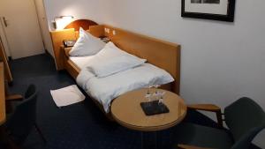 Vuode tai vuoteita majoituspaikassa Hotel Unger