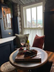 a table with a bottle of wine and a glass at The Tobacco Loft in Kendal +11 photos