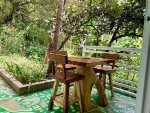 a wooden table and two chairs sitting on a patio at Nan La Tigra in El Rosario