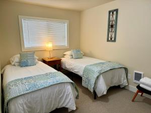 a bedroom with two beds and a window at Great downtown Sandpoint location! in Sandpoint