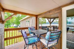a porch with a table and chairs on a deck at Lakefront Cabin in Jay with Deck, Views and Boat Ramp! in Jay
