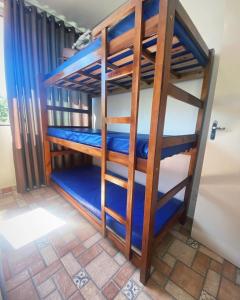 a bunk bed in a room with blue bunk beds at SITIO AMANHECER VERDE in Contagem