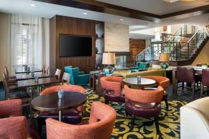 a hotel lobby with tables and chairs and a flat screen tv at Residence Inn by Marriott Los Angeles Pasadena/Old Town in Pasadena