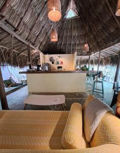 a living room with a couch and a bar at Magdalena Beach House in Los Naranjos