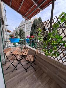 a balcony with two chairs and potted plants at Byout Beirut’s M1 in Beirut