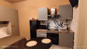 a small kitchen with a sink and a bed in a room at Alle Volte Petite Maison in Giovinazzo