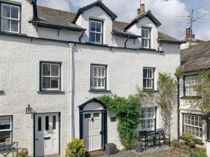 a white house with white doors and windows at Ross Cottage in Hawkshead