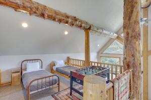 a bedroom with two bunk beds and a balcony at Rustic Sterling Cabin Walk to Palisade Lake! in Sterling