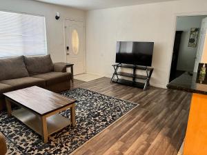 a living room with a couch and a flat screen tv at Lovely 1bed,1bath condo with free parking in Fresno