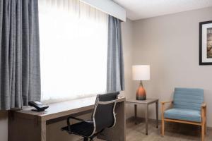 a room with a desk and a chair and a window at Best Western Plus King's Inn and Suites in Kingman