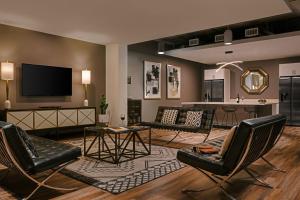 a living room with chairs and a flat screen tv at Sonder Midtown South in Atlanta