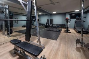 a gym with tread machines and a mirror at Radisson Blu 1919 Hotel, Reykjavík in Reykjavík