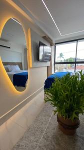 Una televisión o centro de entretenimiento en Flat beira-mar em Porto de Galinhas 35 fotos más