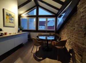 a room with a table and chairs and a brick wall at Charming boutique apartment in Skopje in Skopje