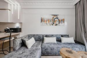 a living room with a couch and a table at Gueliz Luxury Apt with Pool Self Check In 24 7 Security in Marrakech