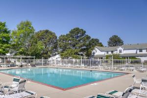 a large swimming pool with chairs and a fence at 2 Mi to Beach Gem with Enclosed Patio in Selbyville in Selbyville