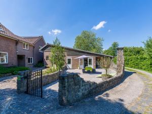 a stone fence in front of a house at Het Grootenhuis in Olst
