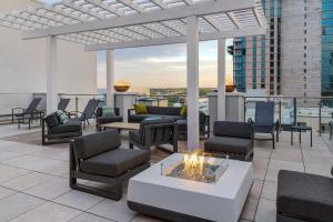 a rooftop patio with chairs and a fire pit at Fairfield by Marriott Inn & Suites Austin Downtown in Austin