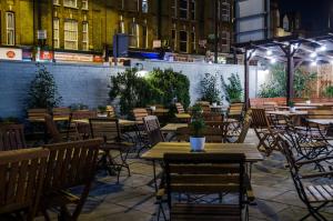 an empty restaurant with tables and chairs at night at Tulse Hill Hotel in London