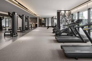 a gym with rows of treadmills and machines at Marriott Executive Apartments Johannesburg, Melrose Arch in Johannesburg