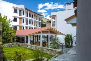 an external view of a building with a red roof at La Chacana Hotel Boutique in Huaraz