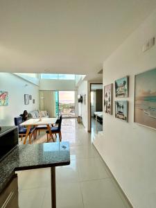 a living room with a table and a dining room at Apartamento Duplex con vista al mar in Gaira