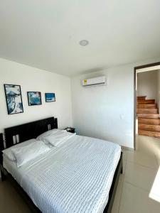 a bedroom with a bed and a staircase in it at Apartamento Duplex con vista al mar in Gaira