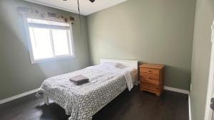 a small bedroom with a bed and a window at Private Room Male Only North Side Edmonton 165 Ave 56 Street Walking Distance to Strip Mall in Edmonton