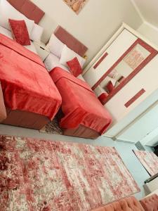 a bedroom with two beds with red pillows at Scandic beach resort in Hurghada