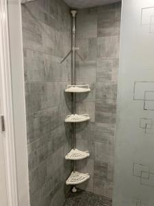 a shower with four shelves on the wall at Scandic beach resort in Hurghada