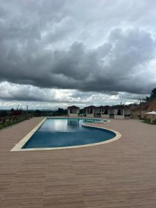 a large swimming pool under a cloudy sky at Temporada 101 in Garanhuns