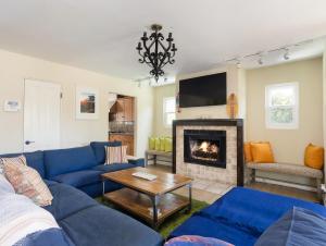 a living room with a blue couch and a fireplace at El Segundo Beach 5B4b Home, POOL Hot Tub, BEACHES, Local Town! in El Segundo