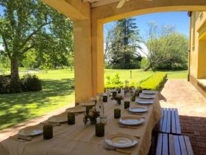 a table set up for a meal on a patio at Espectacular Casa de Campo en Luján in Luján