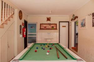 a room with a pool table with balls and bats at Pousada Iguassu Charm Suites in Foz do Iguaçu