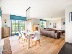 a dining room and living room with a table and chairs at Villa in St-Idesbald near the Sea in Sint-Idesbald