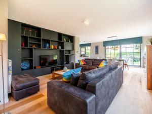 a living room with two couches and a table at Villa in St-Idesbald near the Sea in Sint-Idesbald