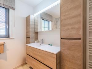 a bathroom with a sink and a mirror at Villa in St-Idesbald near the Sea in Sint-Idesbald +32 photos
