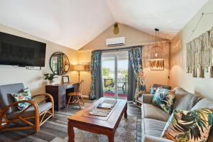 a living room with a couch and a table at Sea Breeze Manor Inn in St Petersburg