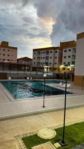 a swimming pool with two lights in front of buildings at Cantinho de paz in Santarém