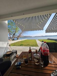 a table with cocacola bottles on it with a view of the water at MR residence in Kovin