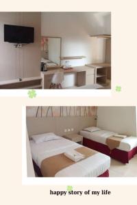 a bedroom with two beds and a happy story of my life at wisma sejahtera hotel in Magelang