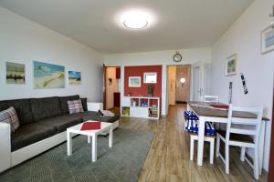 a living room with a couch and a table at Haus Seehund HD04 in Cuxhaven