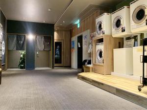 a room with two washing machines on the wall at Hotel Route-Inn Hitachitaga in Hitachi