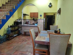 a kitchen with a table and chairs and a kitchen with a counter at Casa Maruja Guest House Zona Romántica in Puerto Vallarta