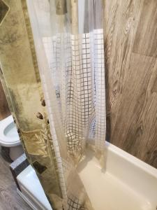 a shower curtain in a bathroom with a toilet at Le1226-Private Room 6 with Free WIFI and Parking in Edmundston