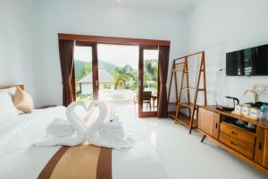 two white swans sitting on top of a bed at Mount Batur Villa in Kintamani +98 photos