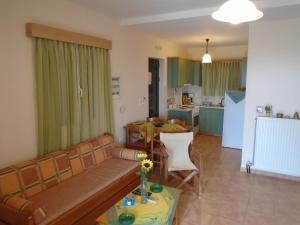 a living room with a couch and a table at Tompras Village in Paralia Demonias +31 photos