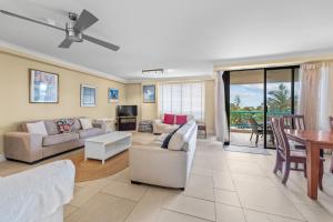 a living room with a couch and a table at Burgess @ Kings Beach Apartments in Caloundra