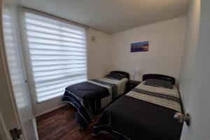 Ένα ή περισσότερα κρεβάτια σε δωμάτιο στο Departamento en Pucon