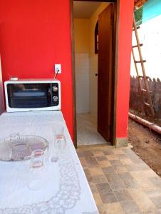 a toaster oven sitting on a table in a room at Villa Pareto Guest House in Macaé